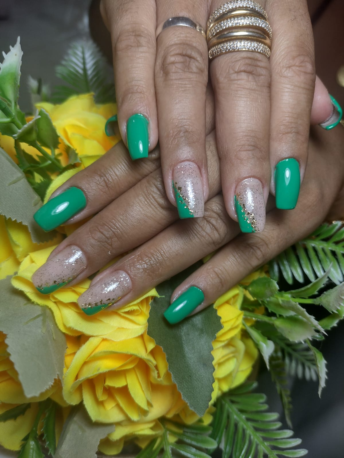 Alongamento de unhas em formato quadrado com esmalte verde e detalhes em glitter dourado